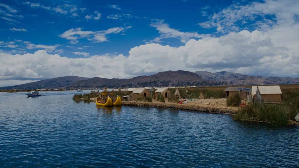 Vista panorámica del Lago Titicaca en Puno, Perú, con sus aguas azul profundo y paisajes andinos.